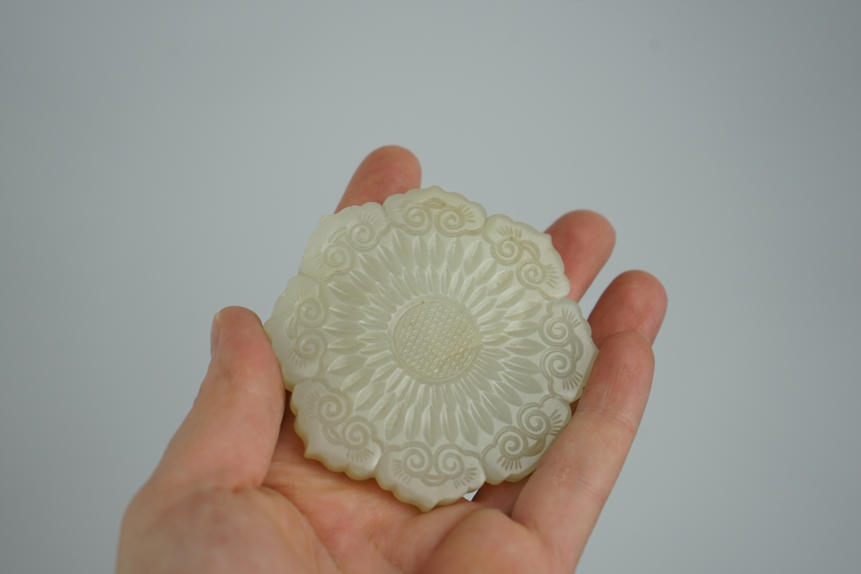 A Chinese pale celadon jade ‘mallow flower’ plaque, 18th/19th century